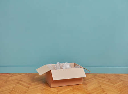 Cardboard box in empty roomの写真素材