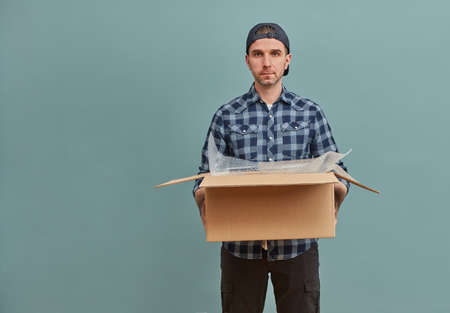 Man with cardboard box on green