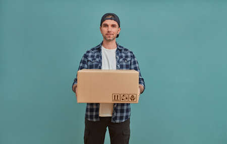Cheerful man with cardboard boxの写真素材