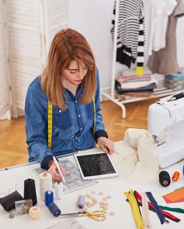 Young seamstress woman in her workshopの写真素材