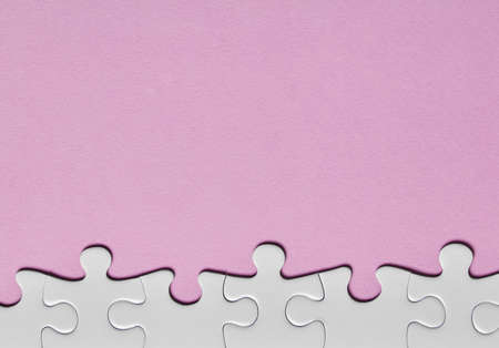 Puzzle border close-up on pink backgroundの写真素材