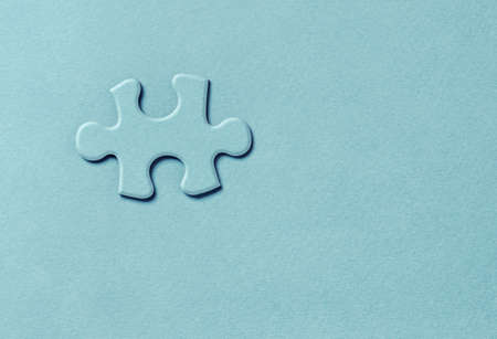Embossed puzzle piece on greenの写真素材