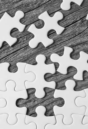 Puzzle pieces on wood backgroundの写真素材