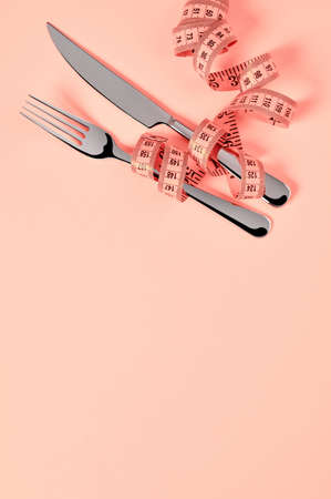 Tape measure and silverware from aboveの写真素材