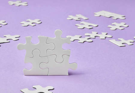 Puzzle pieces on purple backgroundの写真素材