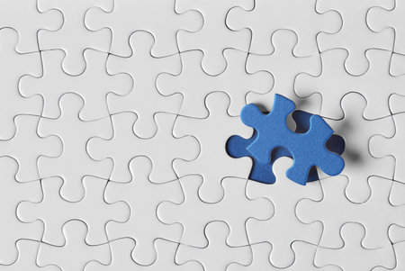 Blue puzzle piece on white puzzle piecesの写真素材