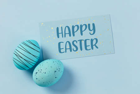 Happy Easter concept on blue backgroundの写真素材