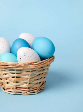 Basket with Easter eggs on blueの写真素材