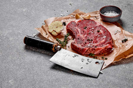 T-bone steak, spices and meat chopperの写真素材