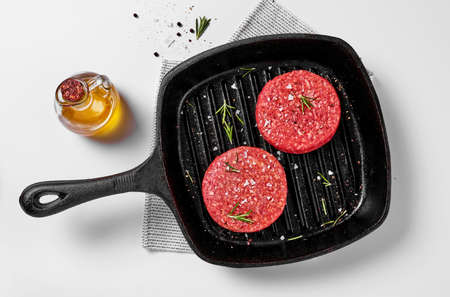 Burgers in a cooking pan on whiteの写真素材