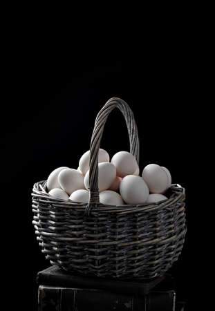 Basket filled with white eggsの写真素材