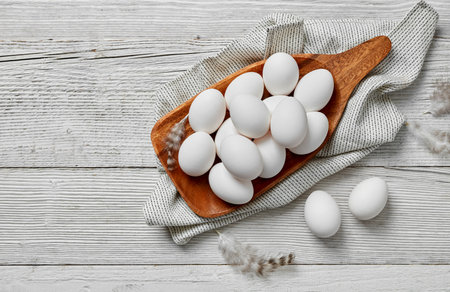 White eggs on wooden tray on white wood backgroundの写真素材