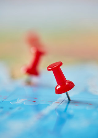 Close-up of red pin on mapの写真素材