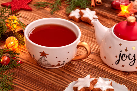 Christmas decor with cup of tea and Christmas ornamentsの写真素材