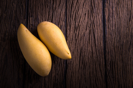 mango ripe on wooden backgroundの写真素材