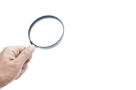 Hand and magnifier as white isolate backgroundの写真素材