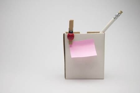 Pencil put in the box and wooden clip as isolate backgroundの写真素材