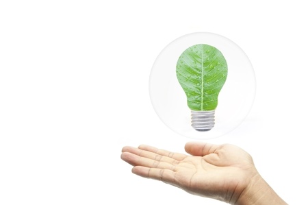 green energy concept hand with leaf in bubbles as white isolate background
