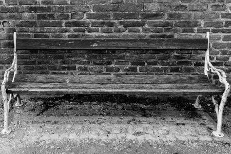 Old chair and an old brick wall in black and whiteの写真素材