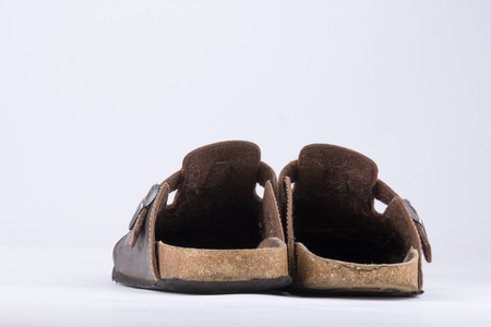 Old slippers made of leather with dog hair on the inside which are heavily usedの写真素材
