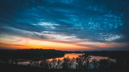 view of the lake at sunset on the top of a hill in Minnesotaの写真素材