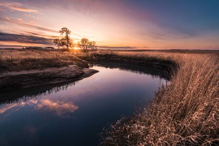 River rolling through the plains of the midwest in the fallの写真素材