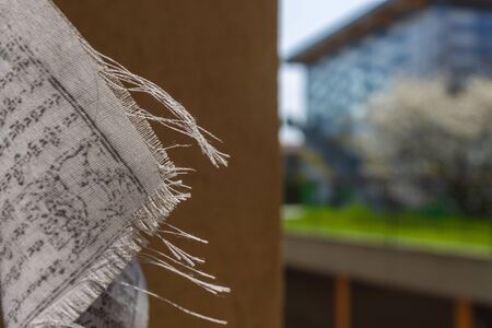 Portion of a prayer tibetan flag against a building