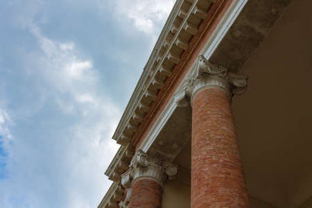 Low angle view of an ancient building against sky and clouds