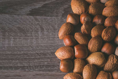 Variety of nuts on a wooden background. Copy space