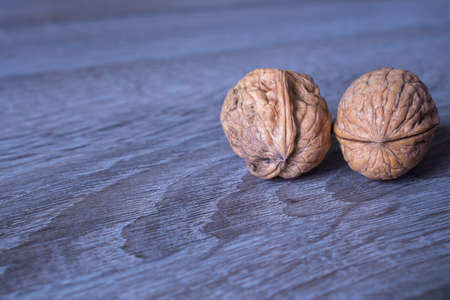 Walnuts in a row on a wooden background. Copy spaceの写真素材