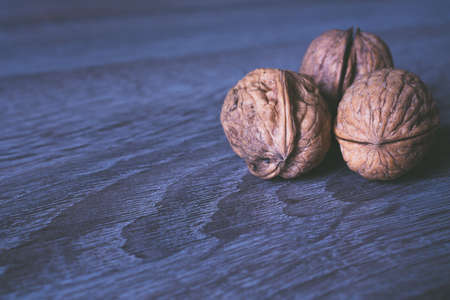 Walnuts in a row on a wooden background. Copy spaceの写真素材