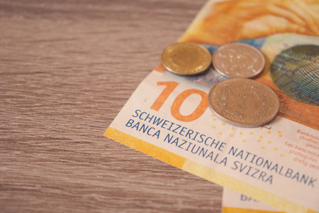 Close-up of Swiss francs currency on a wooden table, with copy spaceの写真素材