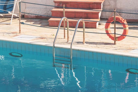 High angle view of an empty swimming pool and a lifebuoy. Concept of safety.