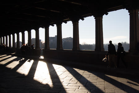 Crossing the covered bridge in Paviaの写真素材