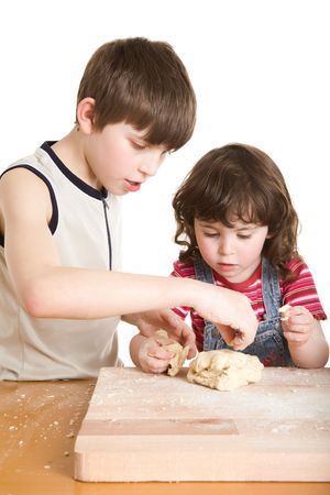 children in the kitchen making a doughの写真素材
