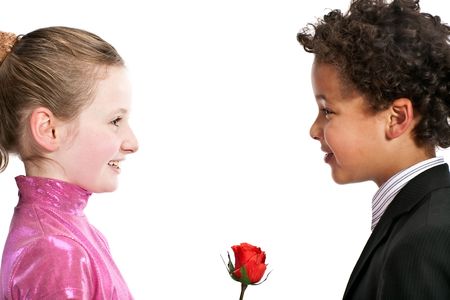 boy giving a rose to a girl, isolated on a white backgroundの写真素材