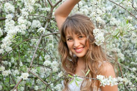 young woman  eating ice-cream in the gardenの写真素材