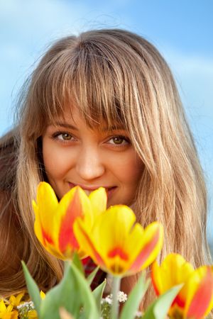 beautiful spring portrait with tulips of blond girlの写真素材