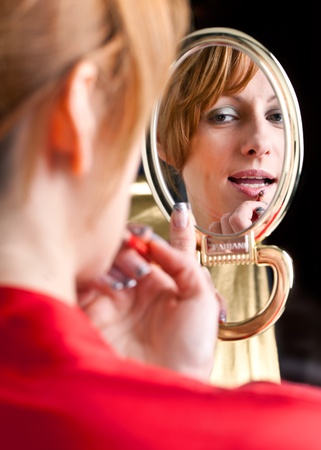 woman looking into a mirrorの写真素材