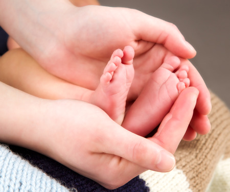 leg newborn little baby in the mothers handsの写真素材