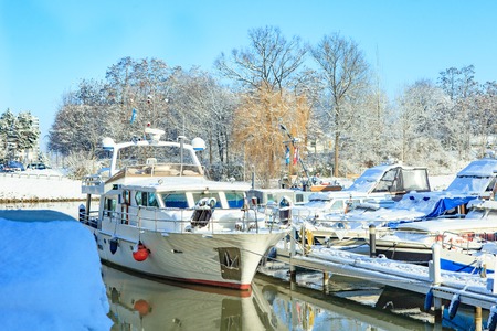 The picturesque landscape of the river, snowy shore on a sunny day in early winterの写真素材