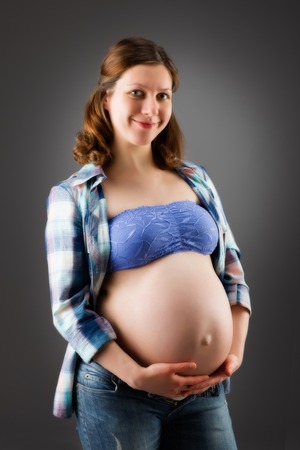 pregnant woman on gray backgroundの写真素材