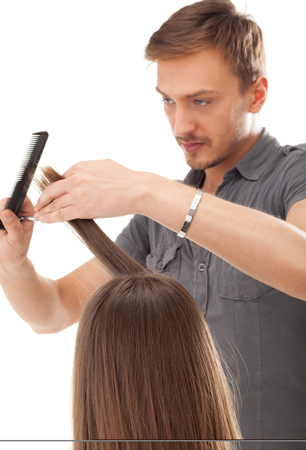 Professional hairdresser with long hair model, isolated on whiteの写真素材