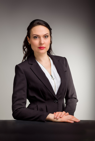Portrait of wonderful business woman on gray backgroundの写真素材
