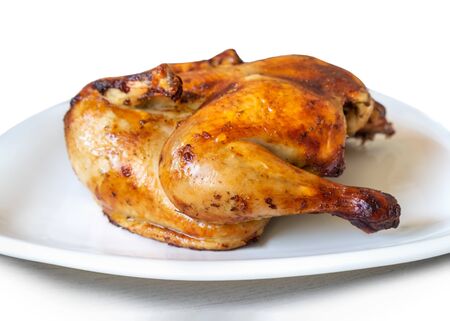 whole gold roasted chicken isolated on white backgroundの写真素材