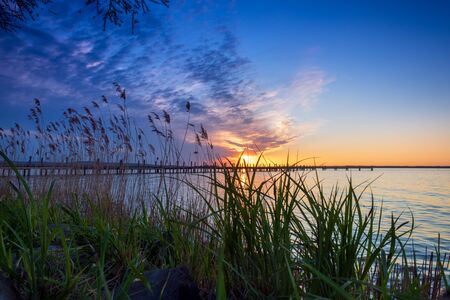 Beautiful romantic colorful sunset over a calm lake