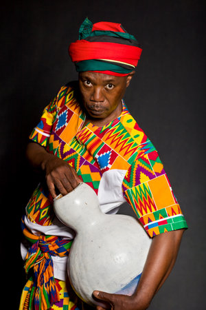 African man in traditional clothes toothy smile, on gray background