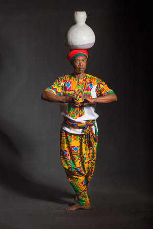 African man in traditional clothes toothy smile, on gray background