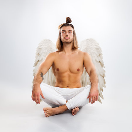 Handsome man angel. Isolated on white background.の写真素材
