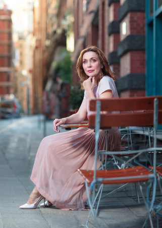 Beautiful successful middle aged woman posing on the street photo shootの写真素材
